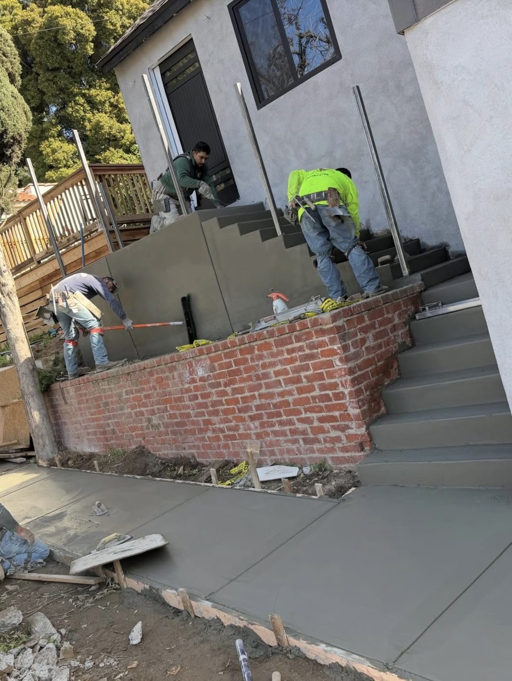 Steps, wall caps and sidewalk being finished together